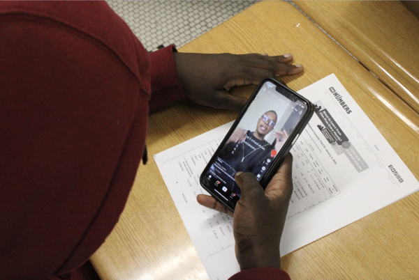 Student scrolling on TikTok in class 